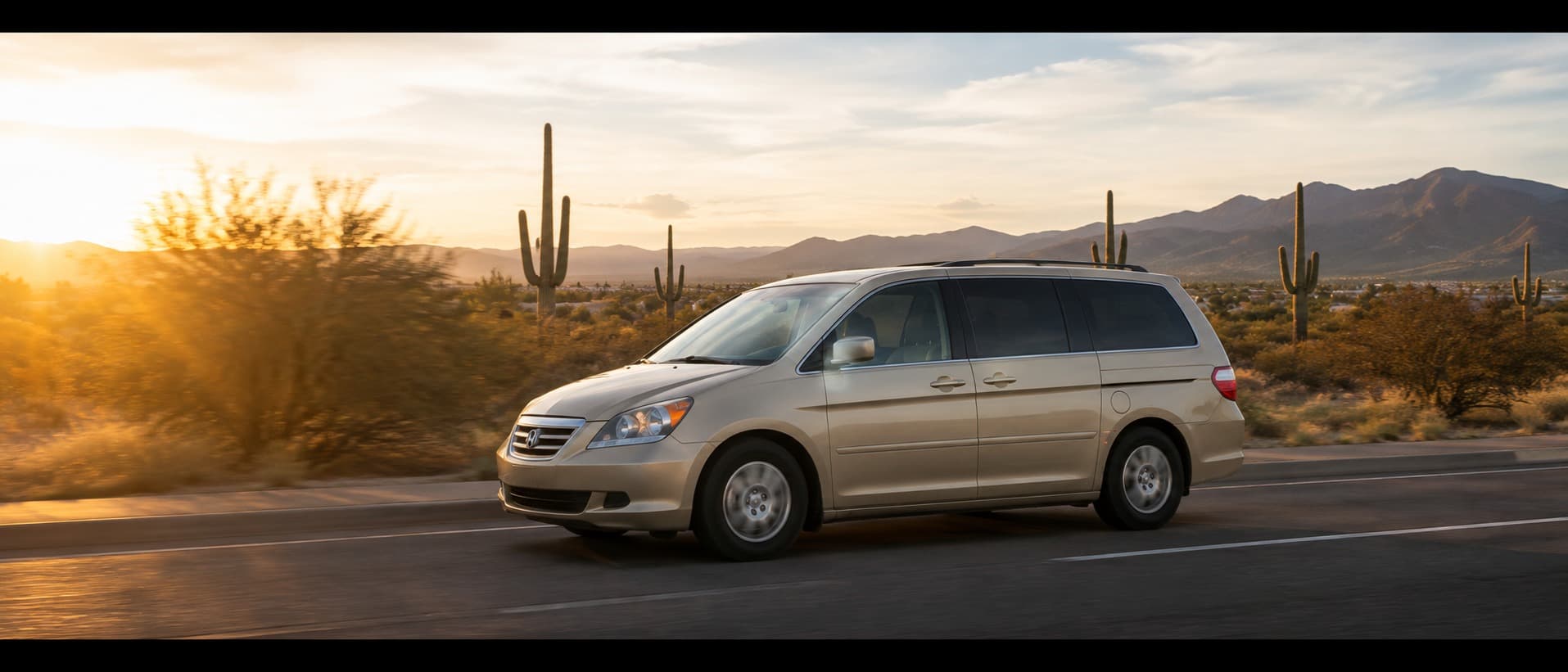 A mobile service van driving through the Arizona desert at sunset